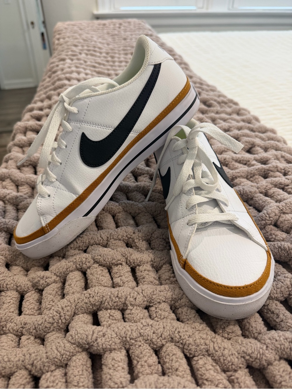Nike Women’s White Sneakers with Black Swoosh and Gold Accent